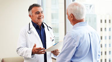 Male doctor talking to male patient