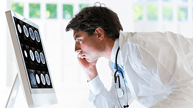 Doctor looking at image on computer.
