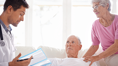 Husband and wife talking with healthcare provider