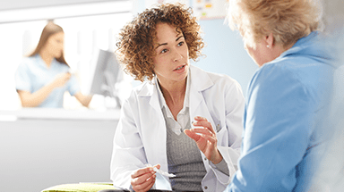 Female doctor talking with female patient