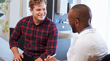 Young Man Speaking With Doctor Image