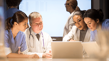 Doctors and nurses talking at a conference table