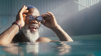 Photo of a man swimming in a pool.