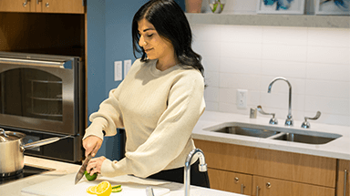 Anglea cutting lemons and limes in the Integrative Oncology kitchen