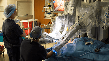 Two doctors in the operating room performing minimally invasive surgery