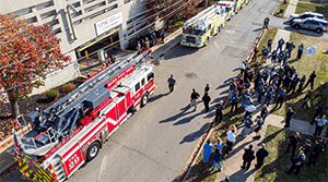 A photo of a large crowd and firetrucks at an event supporting Ryan.