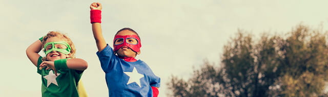 Two kids dressed up as superheroes