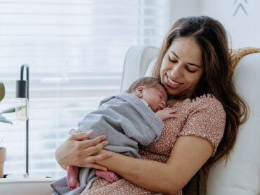 A mom holding her baby