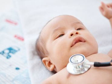 Baby having a well visit exam