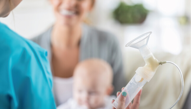 Provider holding a breast pump.