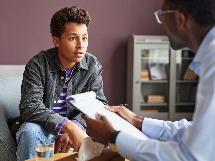 Doctor talking with a teen.