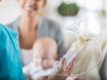 Provider holding a breast pump.