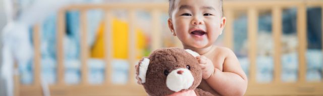 Baby holding a teddy bear