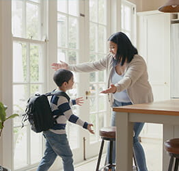 Young boy coming in for a hug with mom