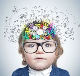 Child with glasses with doodles on and around their head
