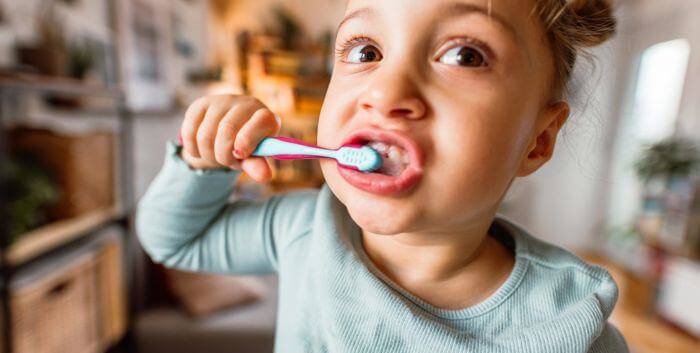 Girl brushing her teeth