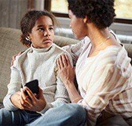 Mother discussing the risks of online human trafficking with daughter