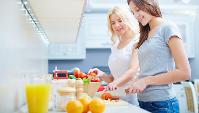 Two teen girls cooking