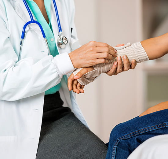 Provider holding a bandage youth arm.