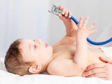 Baby playing with stethoscope