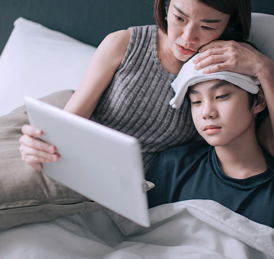 Mother and child looking at tablet.