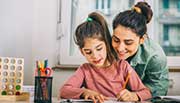 Mom helping girl with her homework