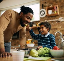 Child sharing food with Dad