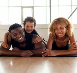 Family laying on their stomaches on the floor
