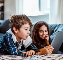 Two kids looking at a mobile tablet