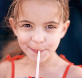 Girl drinking out of a straw
