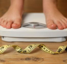 Someone standing on a scale