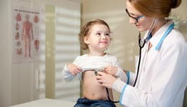 Woman doctor examining child