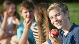 Boy holding an apple