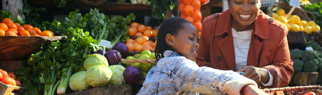 Mom and child shopping in the produce section