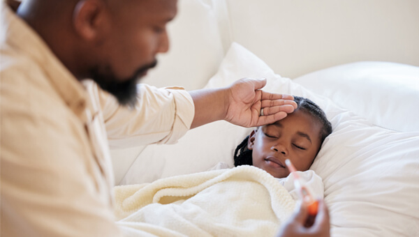 Dad checking his daughters temperature