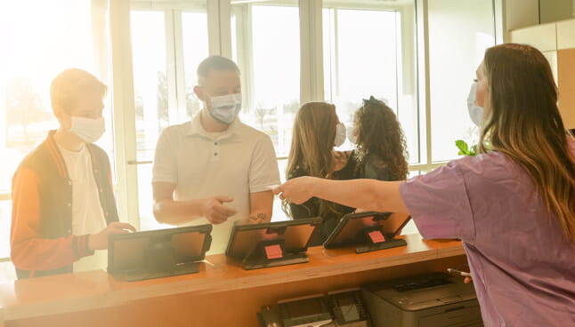 Family checking into a clinic