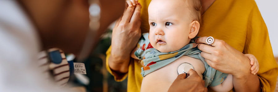 Doctor listening to a baby's heart with a stethoscope