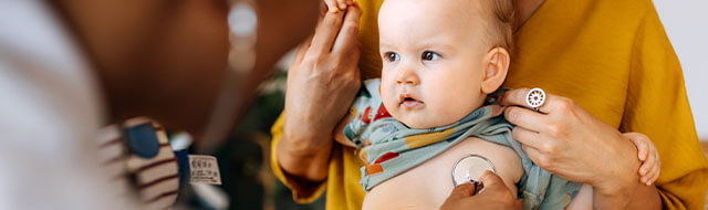 Doctor listening to a baby's heart with a stethoscope