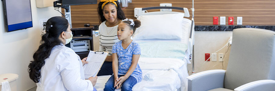 Mother and daughter talking to a doctor