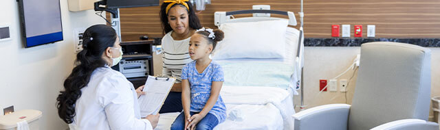 Mother and daughter talking to a doctor