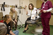 A doctor assists a patient on a visit to the Brachial Plexus Clinic