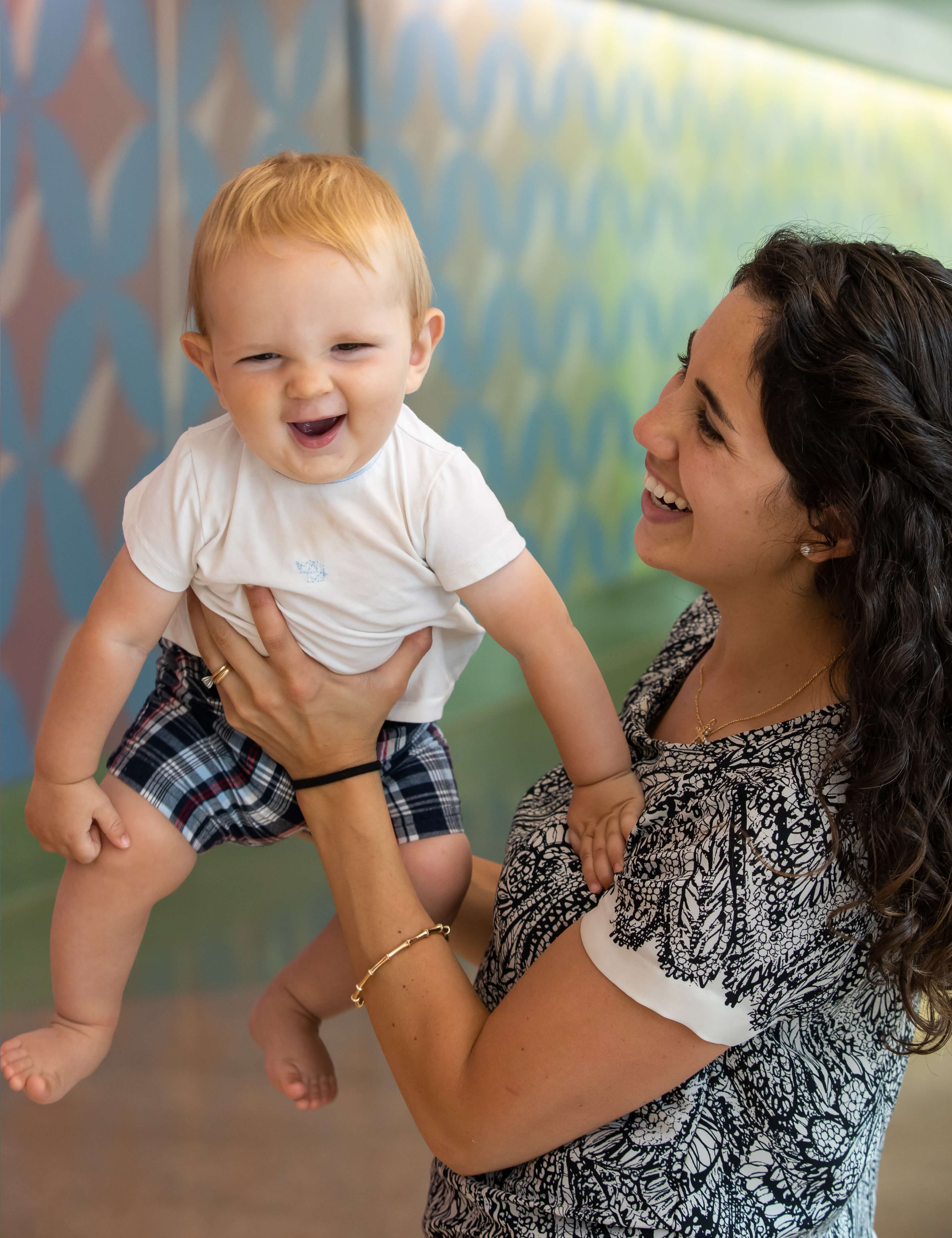 Baby held in the air smiling