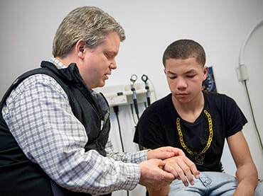 Doctor and young boy in an arm cast