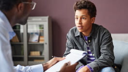 Doctor talking to mother and her young daughter