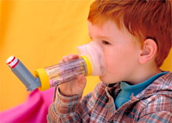 Boy with asthma using an inhaler