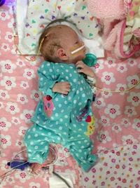 Ella Weisbord as a newborn in a blue patterned onsie