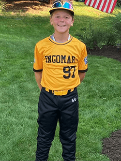 Porter in a black and yellow baseball uniform with his team "Ingomar" on the front