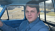Image of Corey in car.