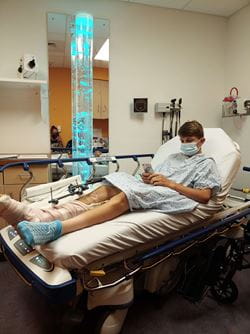 Logan laying in a hospital bed