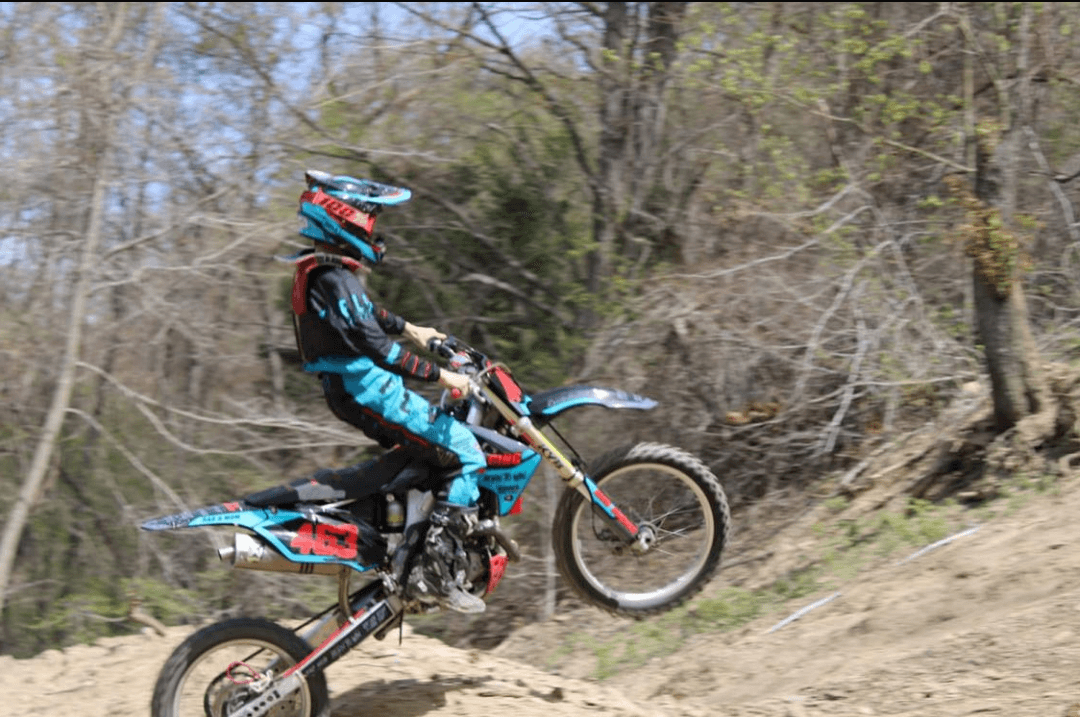 Logan jumping a ramp on his bike